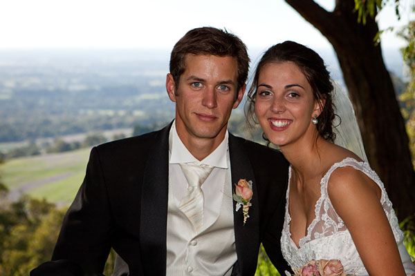 bridal couple posing in front of a vew to Perth