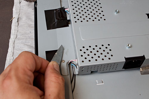 figure 7: screws and backlight cables hidden underneath tape