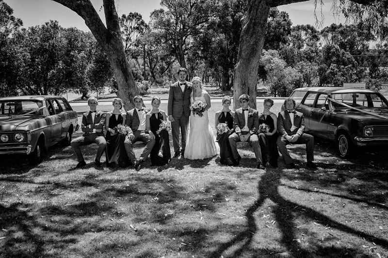 bridal party and cars