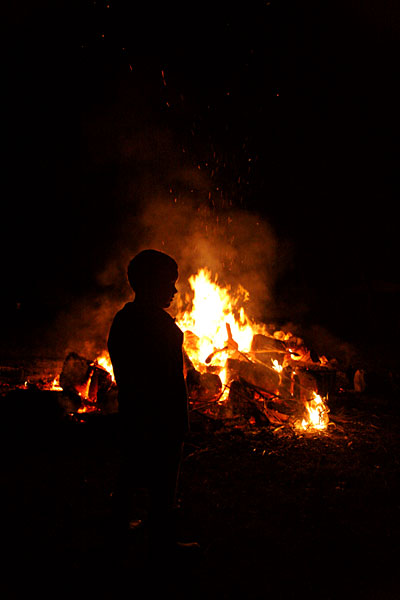 Silhouette in front of bonfire
