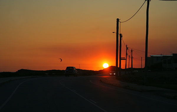Kite-surfer and powerlines at sunset
