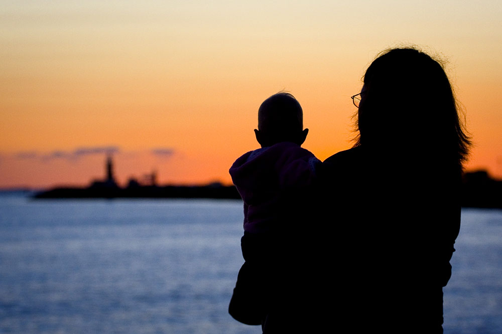 mother and daughter watching the sunset