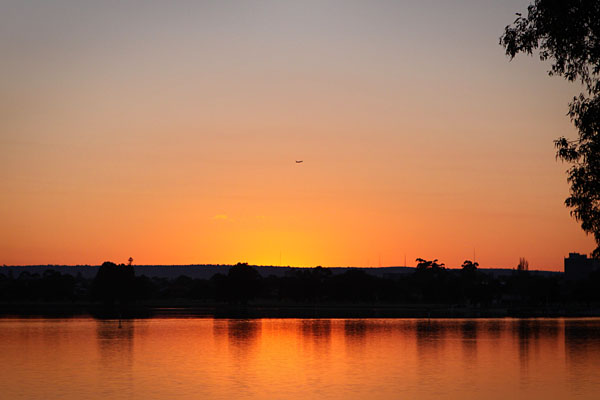 aeroplane taking off over the sunrise