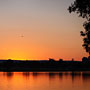 aeroplane taking off over the sunrise