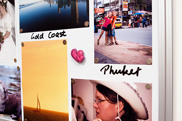 using tiny magnets to hold photos on the board