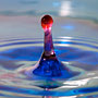 red water dropping into blue water