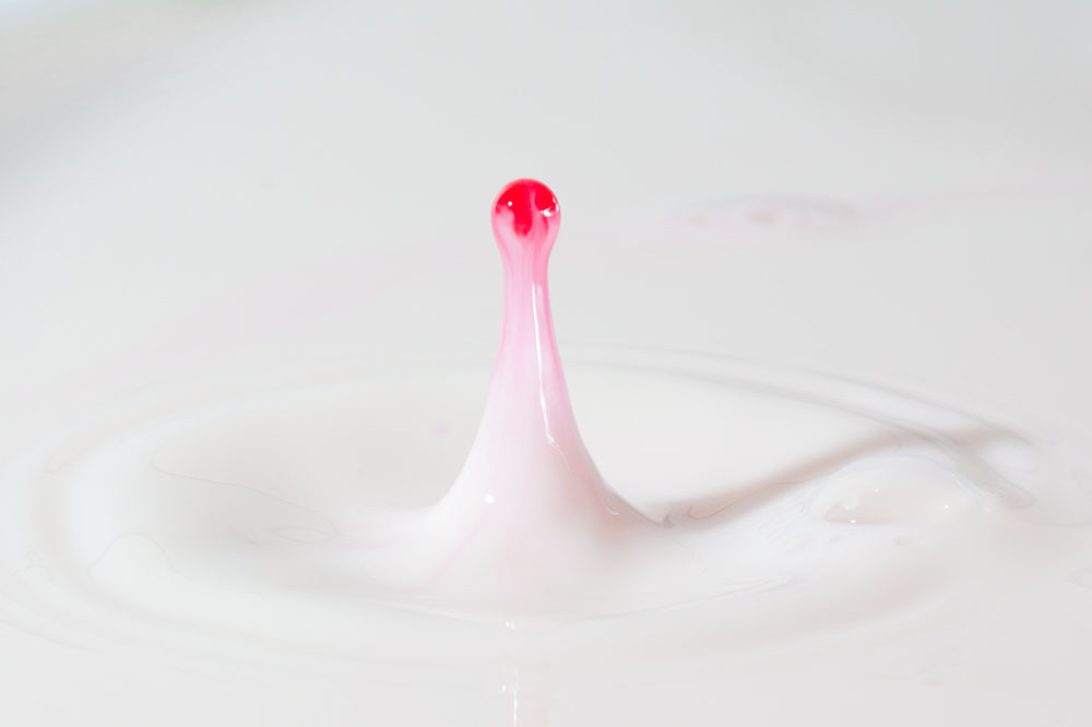 red water dropping into milk