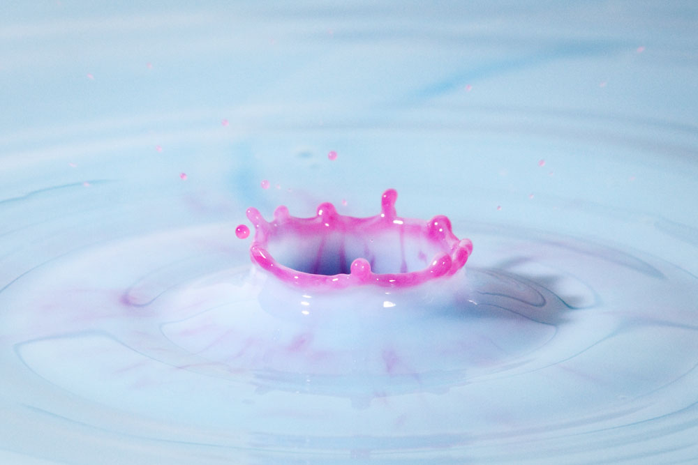 red water dropping into blue milk