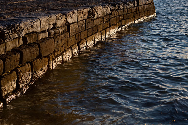setting sun lights up a rock wall