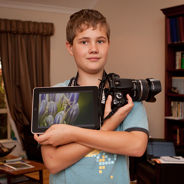 Ashley posing with his iPad and camera
