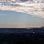 a distant plane over a distant Perth city