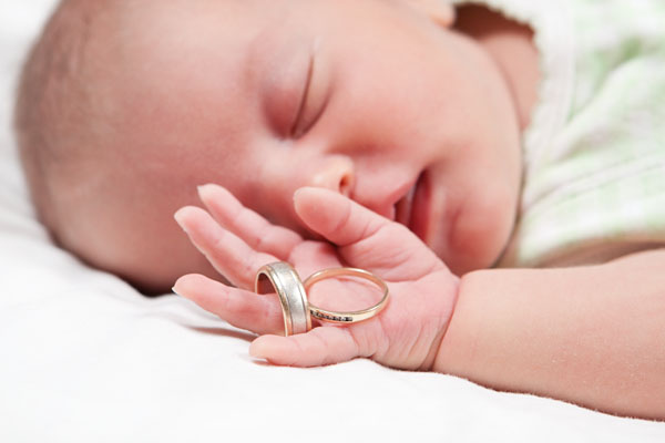 holding her mum and dad's wedding rings