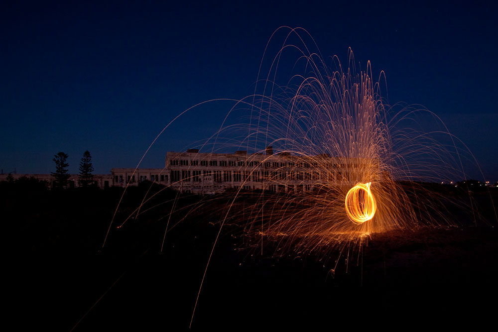 steel wool spinning in front of the old Fremantle Power Station