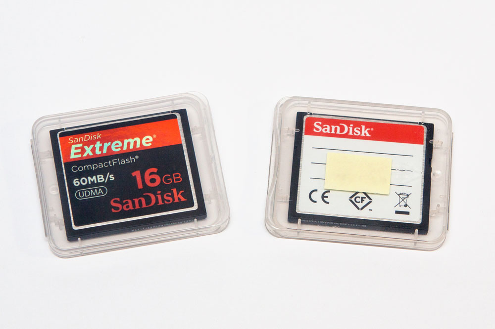 two empty memory cards in their cases (front of memory cards facing AWAY from the label)