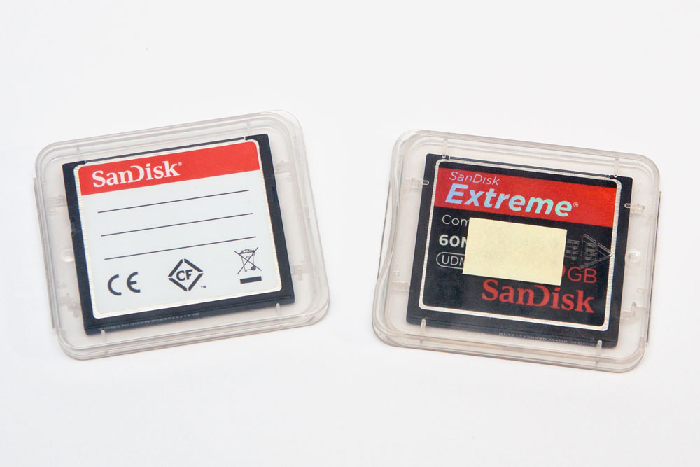 two full memory cards in their cases (front of memory cards facing TOWARDS from the label)