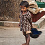 a young boy plays with a motorbike helmet