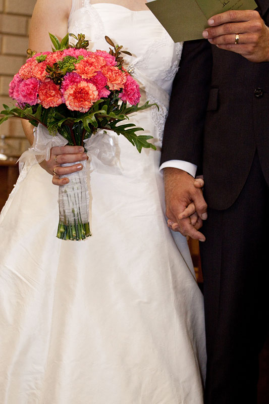 bouquet and clasped hands