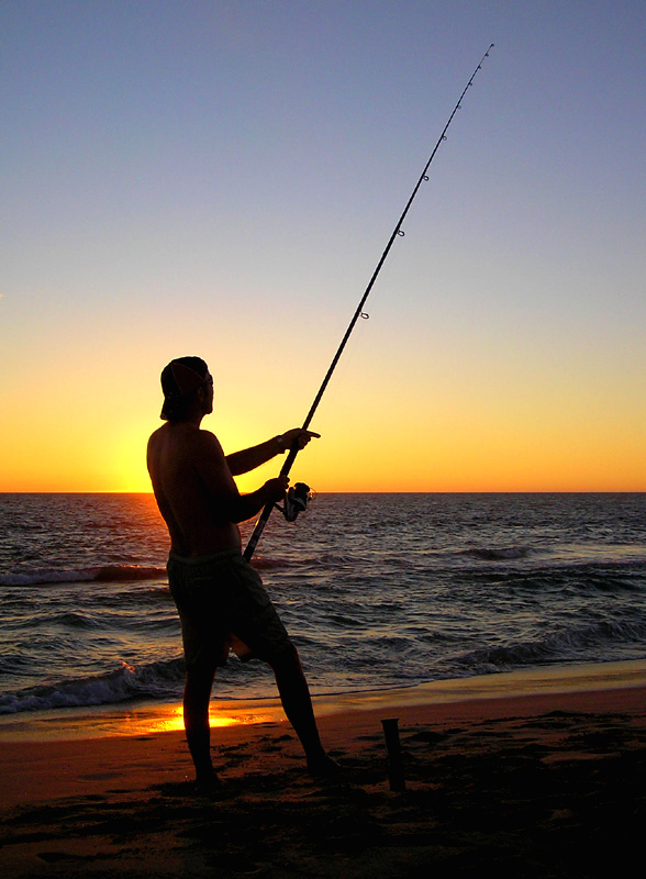 Dennis and fishing rod at sunset